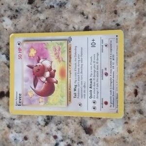 1995 Eevee Pokemon card and a 2015 Vaporeon Pokemon card